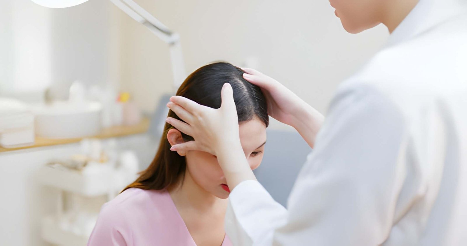 Dermatologist examining a patient's scalp during a hair fall treatment consultation at Skinfollix, a trusted hair clinic in Delhi